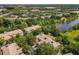 Aerial view of a residential community with a lake and lush greenery at 6240 Miramonte Dr # 102, Orlando, FL 32835