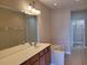 Bathroom features a double sink vanity, large mirror, and separate bathtub at 6240 Miramonte Dr # 102, Orlando, FL 32835