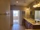Spacious bathroom with double sinks and a doorway leading to a bedroom at 6240 Miramonte Dr # 102, Orlando, FL 32835