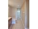 Well-lit bathroom with a walk-in closet and tiled floors leading to the bath at 6240 Miramonte Dr # 102, Orlando, FL 32835