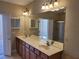 Bathroom features double sinks, wooden cabinets, and a walk-in shower at 6240 Miramonte Dr # 102, Orlando, FL 32835