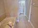 Bathroom featuring a built-in bathtub and tiled flooring at 6240 Miramonte Dr # 102, Orlando, FL 32835
