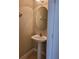 Small bathroom with a pedestal sink and round mirror at 6240 Miramonte Dr # 102, Orlando, FL 32835
