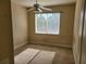 Bedroom with neutral carpet, ceiling fan, and window providing natural light and views at 6240 Miramonte Dr # 102, Orlando, FL 32835