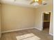 Spacious bedroom featuring a ceiling fan and an en-suite bathroom entry for added convenience at 6240 Miramonte Dr # 102, Orlando, FL 32835