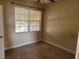 Cozy bedroom featuring neutral carpet, ceiling fan, and window allowing for natural light at 6240 Miramonte Dr # 102, Orlando, FL 32835