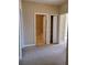 Bedroom with neutral carpet, walk-in closet, and doorways leading to bathroom and other rooms at 6240 Miramonte Dr # 102, Orlando, FL 32835
