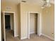 Bedroom featuring neutral carpet, closet with bi-fold doors, and two doorways at 6240 Miramonte Dr # 102, Orlando, FL 32835