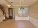 Bright dining area featuring tile floors, a decorative hanging light fixture, and large window with blinds at 6240 Miramonte Dr # 102, Orlando, FL 32835