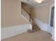 Welcoming entryway with staircase, tile flooring, and decorative wall molding for an elegant look at 6240 Miramonte Dr # 102, Orlando, FL 32835