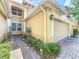 Attached one car garage with brick paver driveway and manicured landscaping at 6240 Miramonte Dr # 102, Orlando, FL 32835