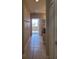 Inviting hallway leads to a bright room with tile flooring and neutral paint at 6240 Miramonte Dr # 102, Orlando, FL 32835