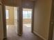 Bright hallway featuring neutral carpet leading to various rooms and windows for natural light at 6240 Miramonte Dr # 102, Orlando, FL 32835