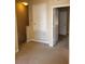 Upstairs hallway featuring neutral carpet and white doors leading to other rooms of the home at 6240 Miramonte Dr # 102, Orlando, FL 32835