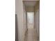 Hallway with white doors, neutral walls, and tile flooring leading to rooms at 6240 Miramonte Dr # 102, Orlando, FL 32835