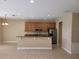 Modern kitchen with stainless steel appliances and granite countertops, seamlessly connecting to the living area at 6240 Miramonte Dr # 102, Orlando, FL 32835