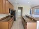 Well-equipped kitchen with granite countertops, stainless steel appliances, and tile backsplash at 6240 Miramonte Dr # 102, Orlando, FL 32835
