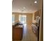 Bright kitchen showcasing granite counters, stainless appliances and tile floors at 6240 Miramonte Dr # 102, Orlando, FL 32835