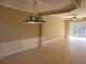 Spacious living room with neutral walls, tiled floors, ceiling fan, and crown molding at 6240 Miramonte Dr # 102, Orlando, FL 32835