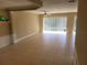 Bright living room features tile floors, neutral walls, and large sliding glass doors to the backyard at 6240 Miramonte Dr # 102, Orlando, FL 32835