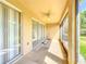 Enclosed outdoor patio has a ceiling fan and tiled floor for a relaxing outdoor space at 6240 Miramonte Dr # 102, Orlando, FL 32835