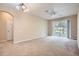 View of the living room featuring carpet, a ceiling fan and sliding glass doors to screened patio at 6402 Cava Alta Dr # 107, Orlando, FL 32835