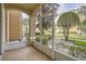 Screened patio with a view of the landscaping and surrounding buildings at 6402 Cava Alta Dr # 107, Orlando, FL 32835