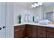 Stylish bathroom featuring a vanity with dark wood cabinets, solid surface countertop, and modern fixtures at 6524 Calamondin Dr, Winter Garden, FL 34787