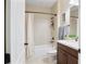 Clean bathroom with a tub, shower, tiled walls, and vanity with dark wood cabinets at 6524 Calamondin Dr, Winter Garden, FL 34787