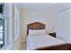 Sunlit bedroom with wood-framed bed, closet and bright window showcasing the outdoors at 6524 Calamondin Dr, Winter Garden, FL 34787