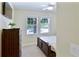 Cozy bedroom featuring two windows with palm tree views and a ceiling fan at 6524 Calamondin Dr, Winter Garden, FL 34787
