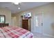 Spacious bedroom with a mounted TV, door to balcony and wood dresser at 6524 Calamondin Dr, Winter Garden, FL 34787