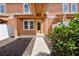 Inviting townhome with a bright yellow front door and landscaped front yard at 6524 Calamondin Dr, Winter Garden, FL 34787
