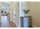 Entryway featuring hardwood floors, a decorative cabinet, and an open view into the living room at 6524 Calamondin Dr, Winter Garden, FL 34787