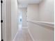 Bright hallway with neutral walls and carpet leads to bedrooms and attic access at 6524 Calamondin Dr, Winter Garden, FL 34787