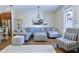 Cozy living room features a large sectional sofa, striped ottoman, airplane art, and wood-look tile floors at 6524 Calamondin Dr, Winter Garden, FL 34787
