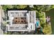 Aerial view featuring the building, its courtyard, nearby pool, personal boat docks, and parking lot at 690 Osceola Ave # 502, Winter Park, FL 32789