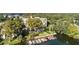 Picturesque aerial view featuring the building with a boat dock, pool, lush trees, and access to the beautiful lake at 690 Osceola Ave # 502, Winter Park, FL 32789