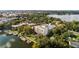 Scenic aerial view showcasing the building, its proximity to the water, lush trees, and the vibrant city in the background at 690 Osceola Ave # 502, Winter Park, FL 32789