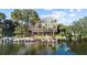 An aerial shot shows a lakeside condominium complex with boat docks and lush greenery at 690 Osceola Ave # 502, Winter Park, FL 32789