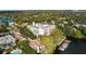 Breathtaking aerial view featuring the lakefront condo building, surrounding trees, and private boat docks at 690 Osceola Ave # 502, Winter Park, FL 32789