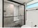 Modern bathroom featuring tiled shower with glass door and updated fixtures at 690 Osceola Ave # 502, Winter Park, FL 32789