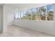 Sunroom-style bedroom featuring light wood floors and lots of natural light through large windows at 690 Osceola Ave # 502, Winter Park, FL 32789