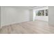Bright bedroom featuring wood floors, white trim, and a wall of windows at 690 Osceola Ave # 502, Winter Park, FL 32789