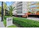 Inviting entrance with lush hedges, modern architecture, and convenient covered parking at 690 Osceola Ave # 502, Winter Park, FL 32789