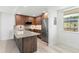 Bright kitchen featuring updated wood cabinets, stainless steel appliances, and island at 690 Osceola Ave # 502, Winter Park, FL 32789