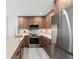 Modern kitchen featuring wood cabinets, stainless steel appliances, and marble countertops at 690 Osceola Ave # 502, Winter Park, FL 32789