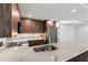 Open kitchen showcasing wood cabinets, marble counters and stainless steel appliances at 690 Osceola Ave # 502, Winter Park, FL 32789