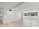 Spacious living space featuring modern finishes, large window and luxury vinyl plank flooring at 690 Osceola Ave # 502, Winter Park, FL 32789