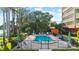 Community pool area with sun loungers and lush tropical landscaping at 690 Osceola Ave # 502, Winter Park, FL 32789